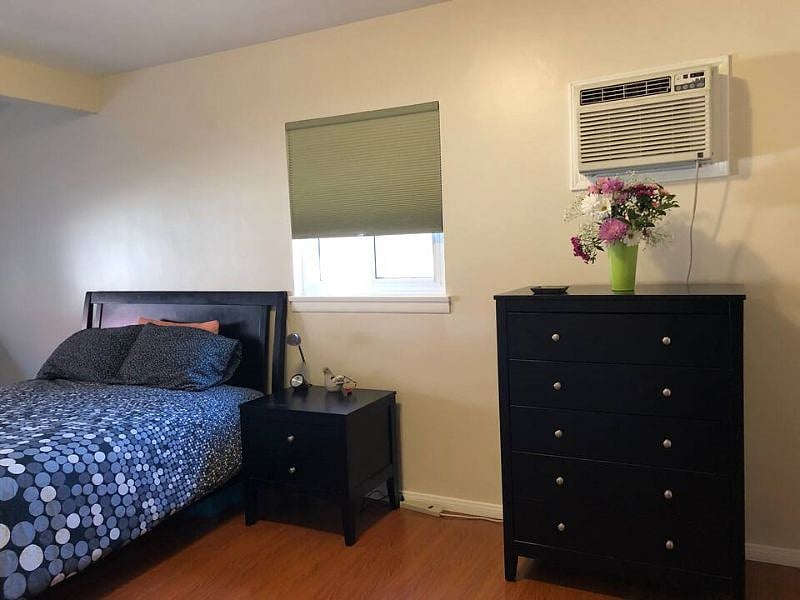 The master bedroom has a private bathroom with access to the backyard, with a luxury Avocado Green Mattress.
