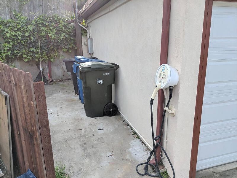 We even have an Electric Vehicle Charger, next to the trash, recycling and compost/yard waste cans.