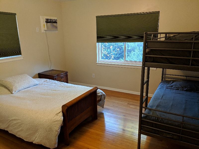 The second bedroom sleeps up to four with a queen-size bed, bunk beds and desk space.