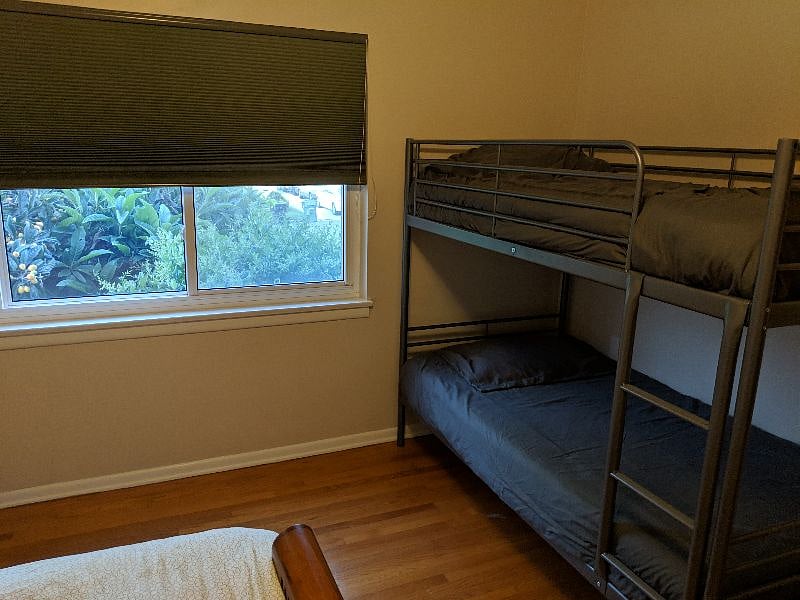 The second bedroom sleeps up to four with a queen-size bed, bunk beds and desk space.