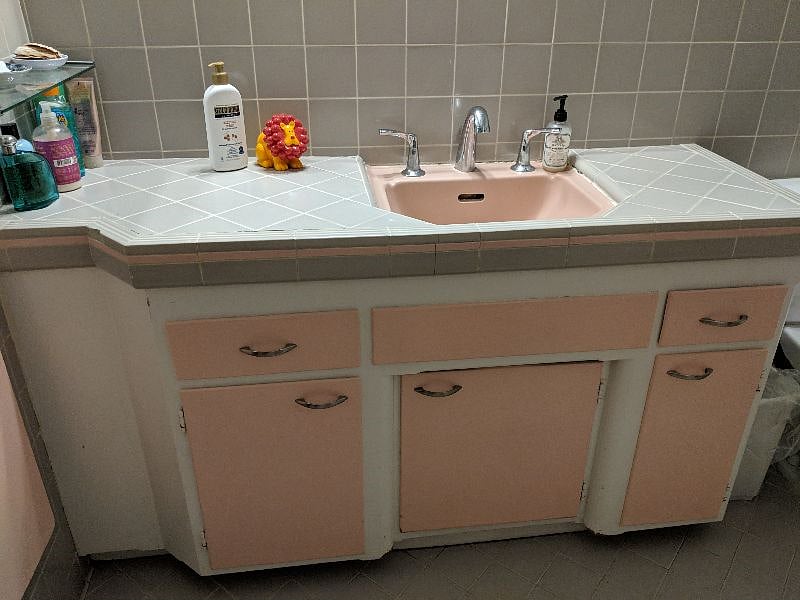 The common bathroom featuring a separate tub and shower. All original tile work.