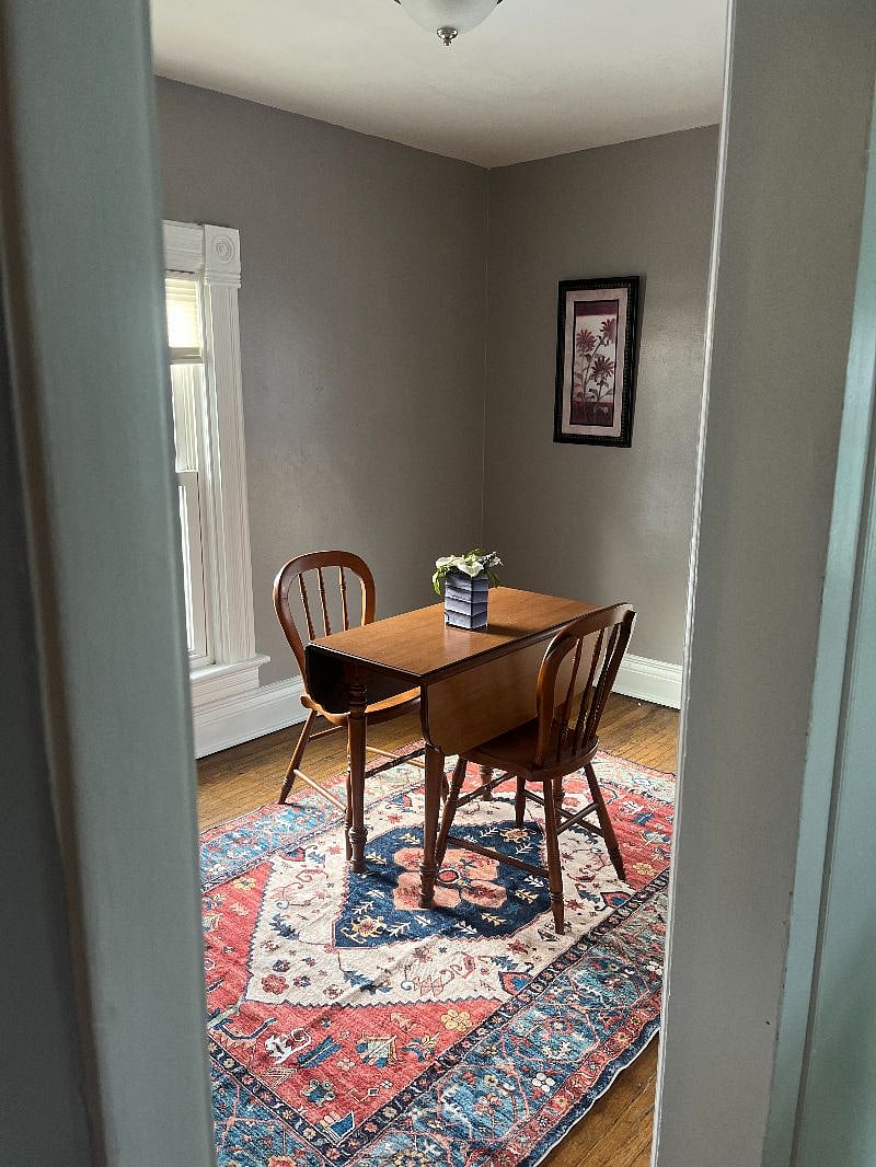 Room to the left of the kitchen, Kitchen table and washer and dryer combo in this room.