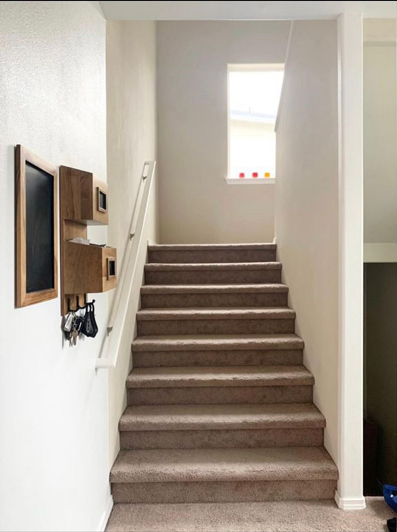Stairs to the bedrooms upstairs and stairs going down the basement. 