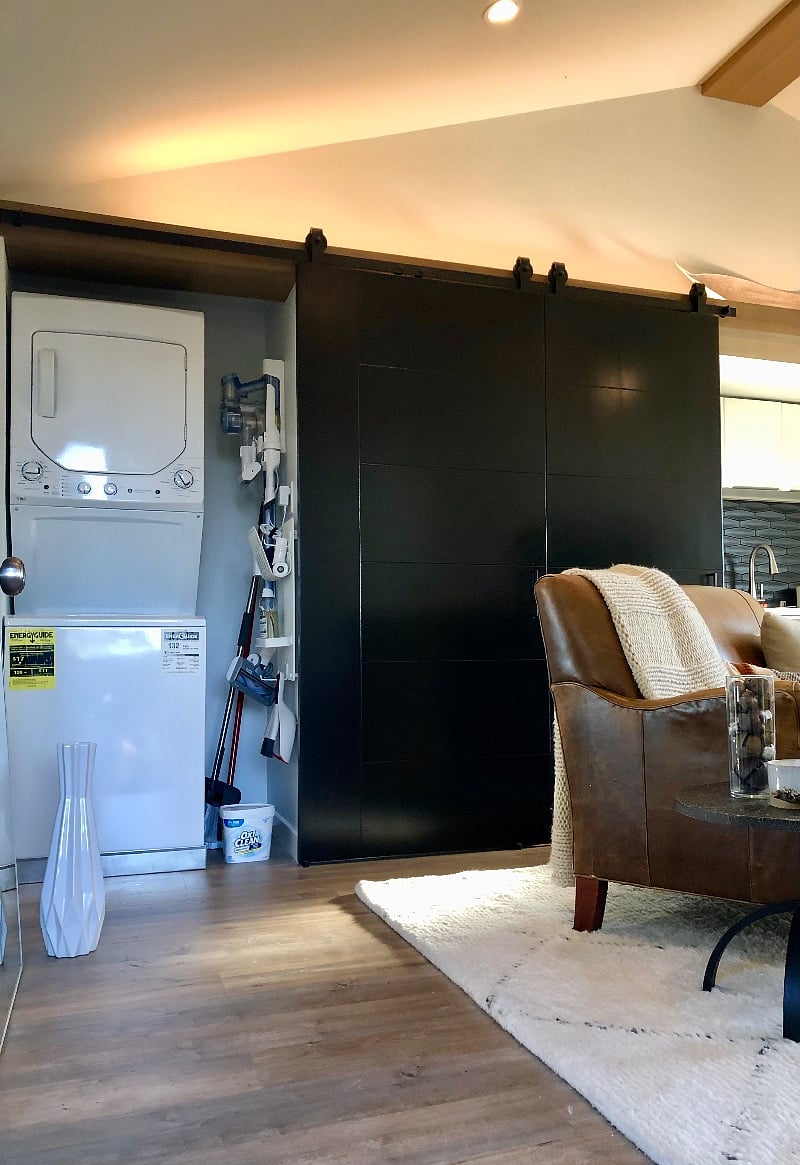 View from main entrance with 2 barn doors open to the washer+dryer unit