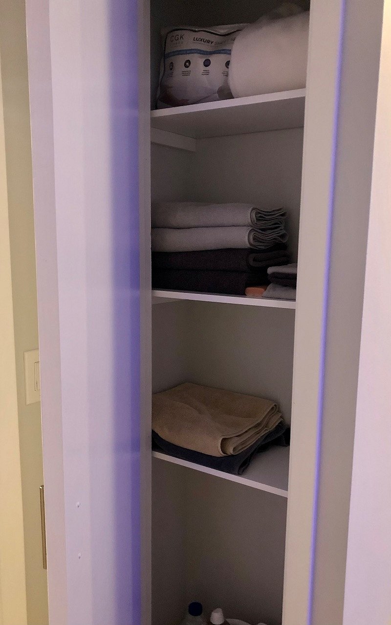 Linen closet in bedroom with towels, extra sheets, a blanket, and more cleaning supplies