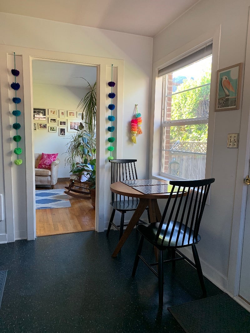 A view from the kitchen into the living room.  The house is decorated with souvenirs I've collected in my travels like the pom-poms seen here from Sayulita, MX. 