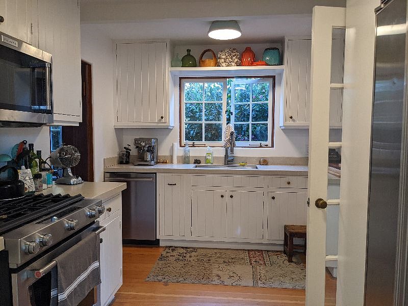 The kitchen is small but mighty! It has a newer range and oven, a sub-zero refrgerator and a Bosch dishwasher.