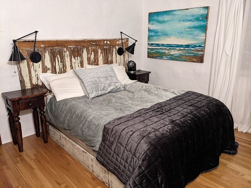 Queen bedroom has Avocado mattress. Room has a walk-in closet, dresser, lounge chair.