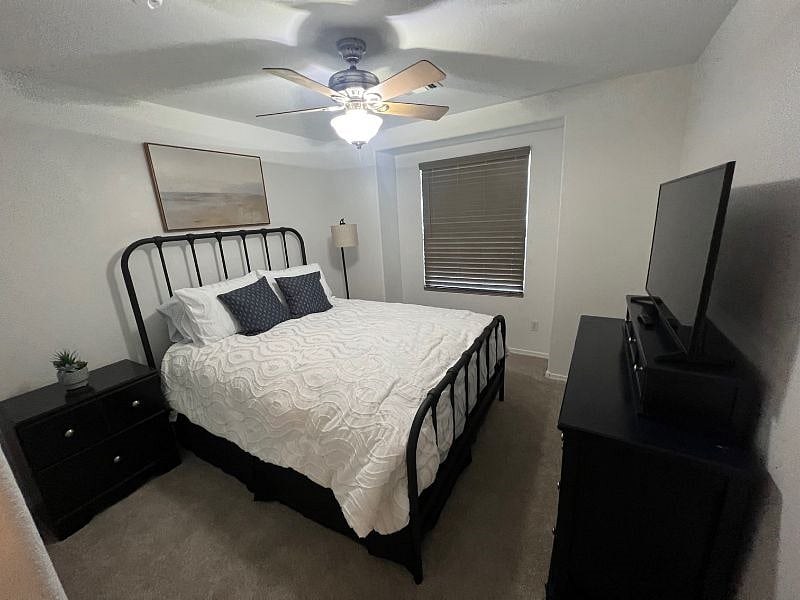 Queen bedroom with large smart tv