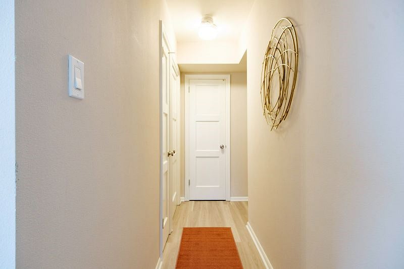 Hallway leading from bedroom area to living room and kitchen.