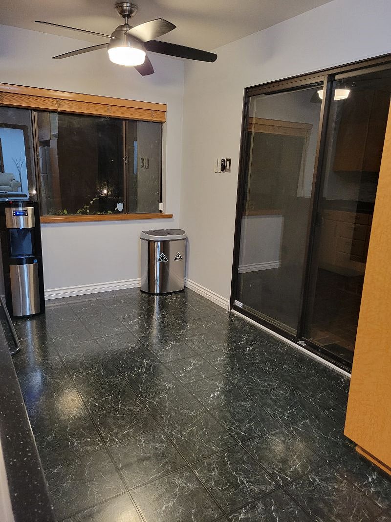 Kitchen with a backyard sliding door, microwave, coffee maker, filtered water, water dispenser hot and cold