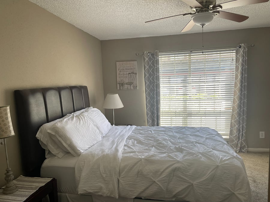 Bright and airy main bedroom allows for comfortable sleep. Room darkening curtains and blinds make for a perfect sleep