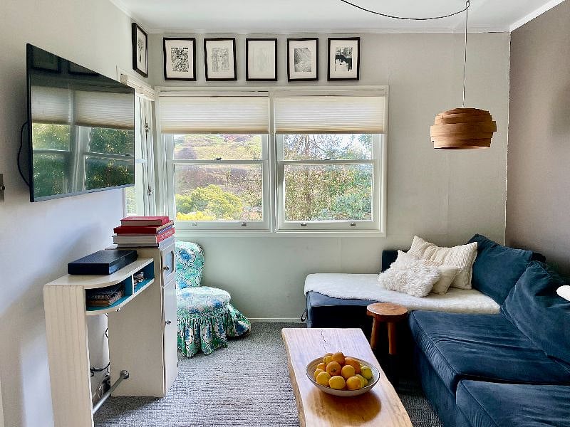 Flat screen TV features cable and streaming channels.