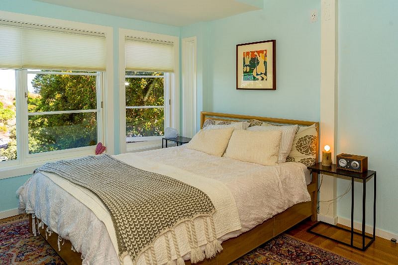 Descend the first flight of stairs to the master bedroom which features a queen bed, master bath, and amazing views.