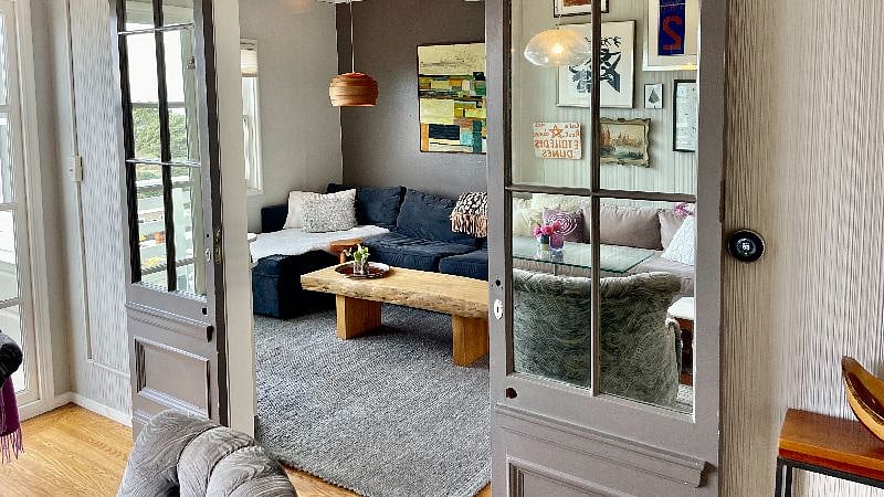 This room with ensuite serves as a TV room or bedroom with rolling vintage closing barn doors.