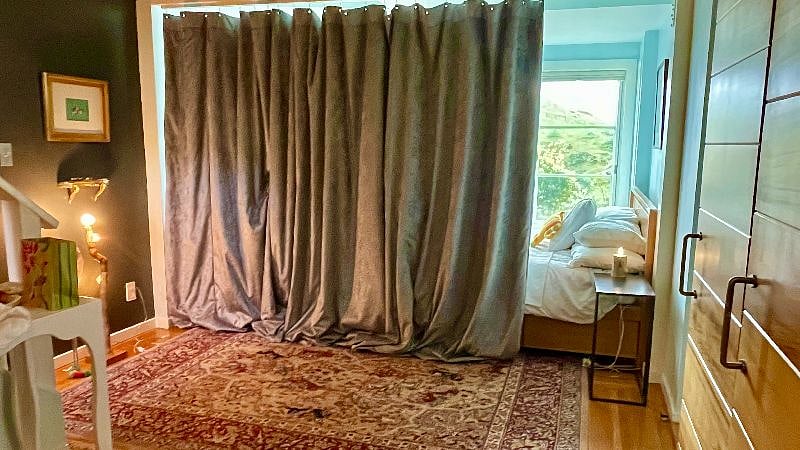 With no door that actually closes to the main bedroom, a velvetty noise-cancelling curtain creates a cozy sleeping zone.