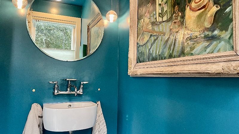 The half bath has a small sink and toilet.