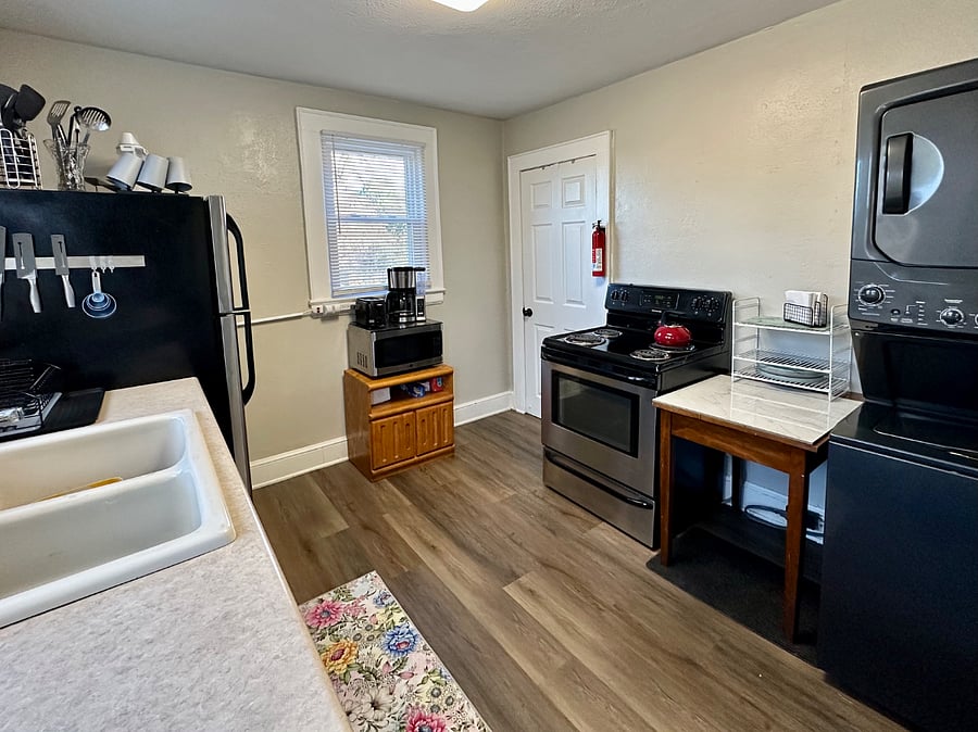 Full size refrigerator, electric range microwave, toaster, coffee pot and cookware.