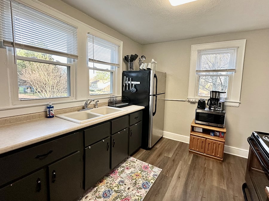 Full size refrigerator, electric range microwave, toaster, coffee pot and cookware.