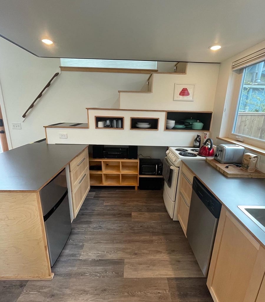 Kitchen with small fridge and dishwasher. Stereo and record player. 
