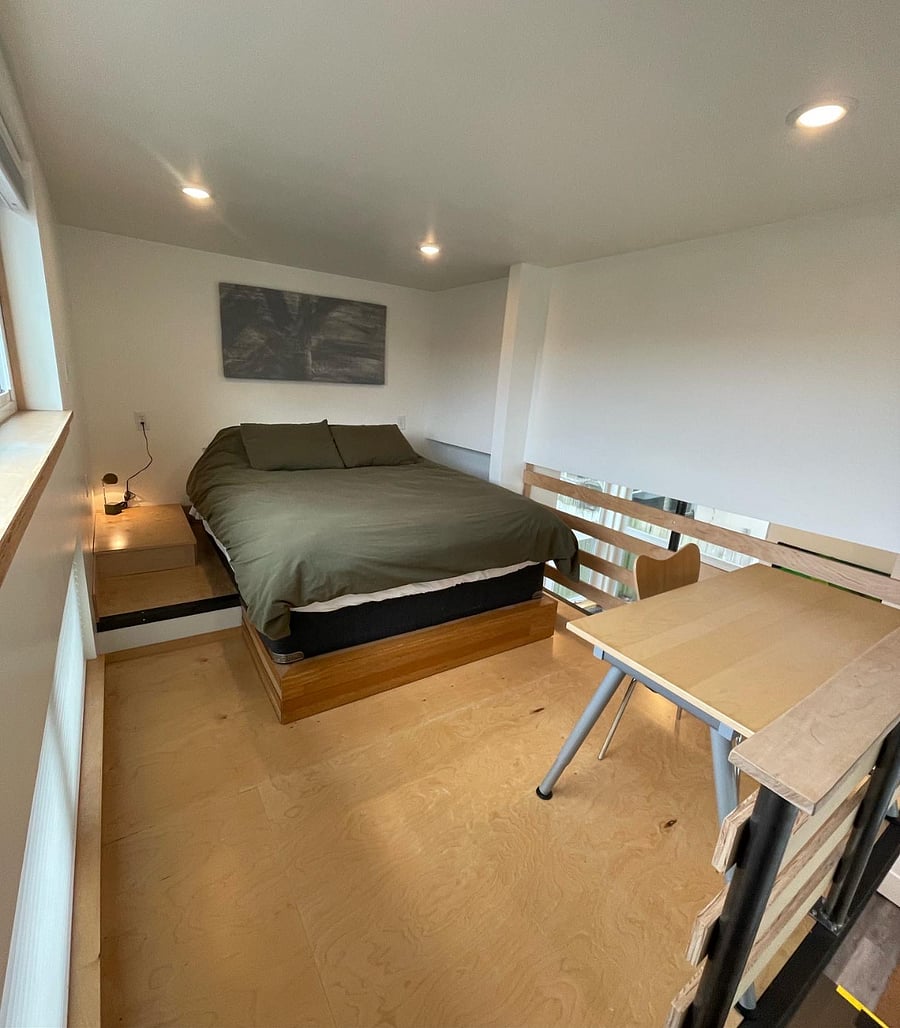 Queen size bed and work table in loft. Blackout blinds. 