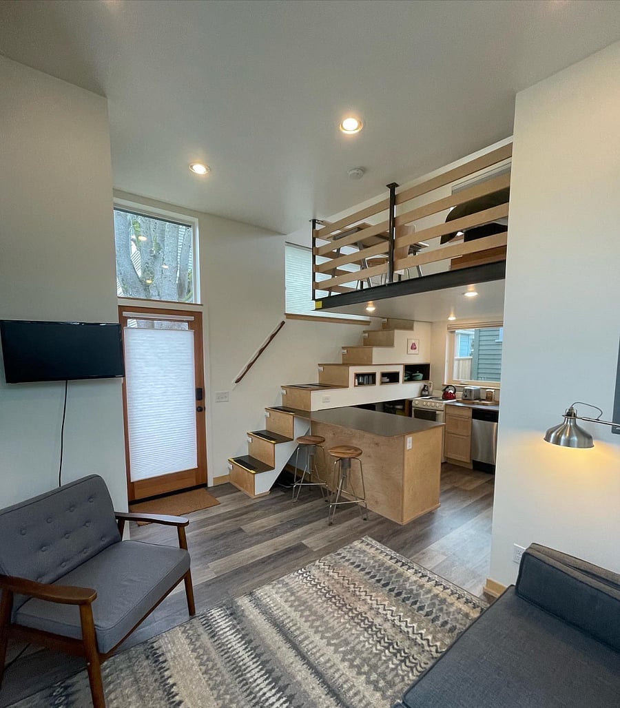 Living room and kitchen. Smart TV, mini split heat and AC unit. Closet space with shelves and area to hang clothes. 