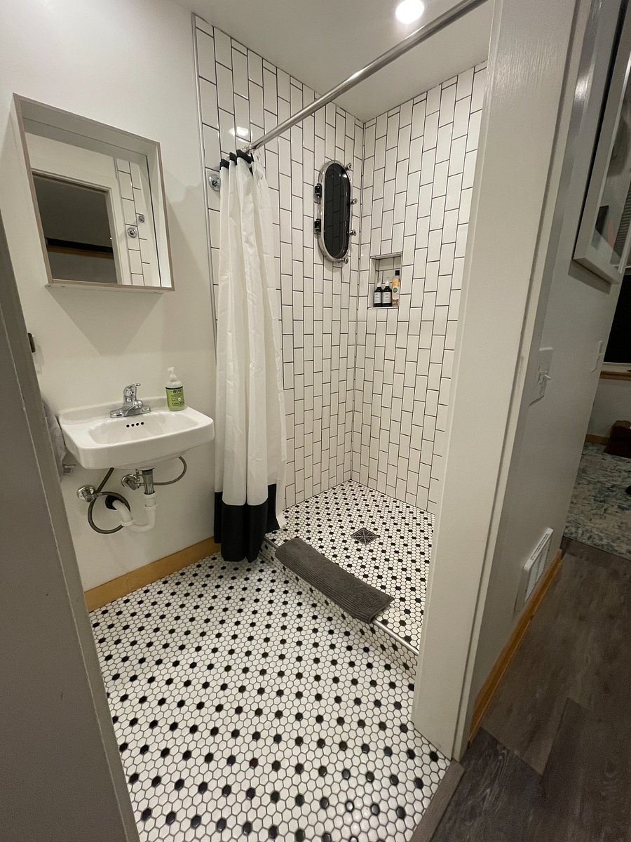Full tiled shower with mini port hole window from a friends boat.