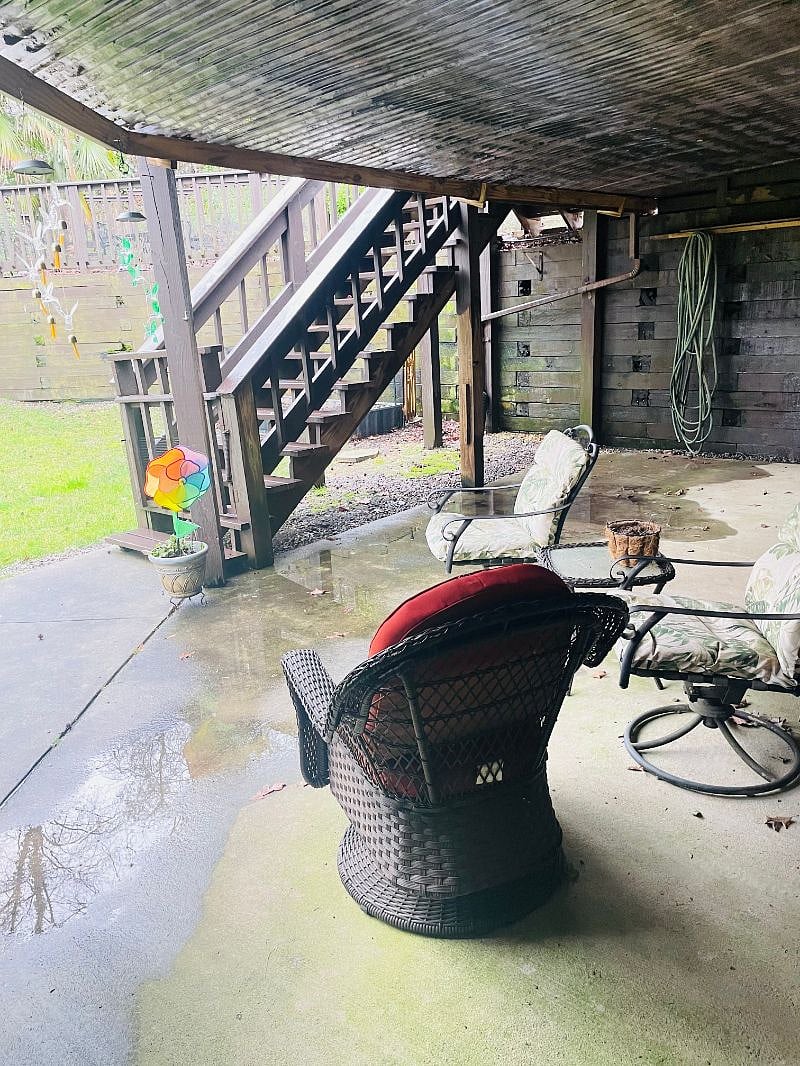 Covered patio walk out to grass and up to pool and hot tub.