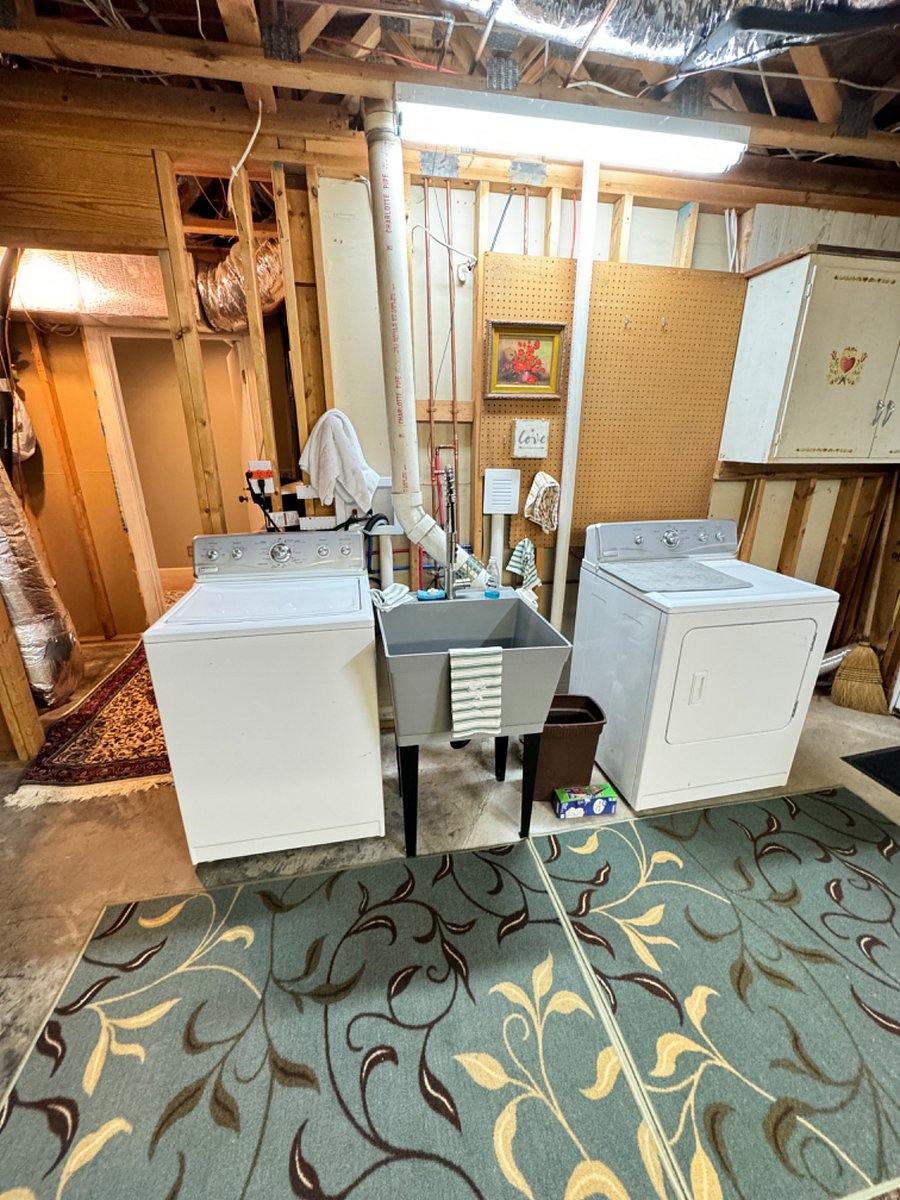 Washer Dryer en suite with utilities sink in the middle