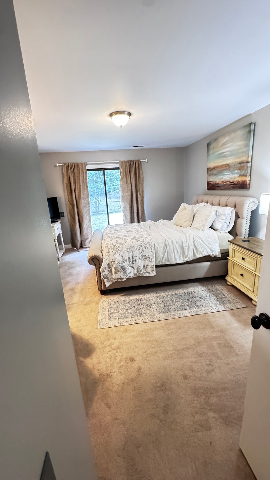 Main bedroom, full-size bed. With a walkout patio.
