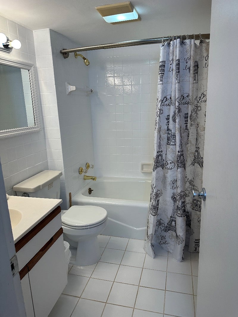 Bathroom inside larger bedroom.