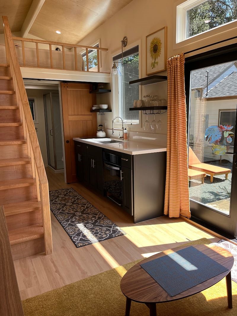Full kitchen, including full-sized oven, induction cooktop, garbage disposal, and all of the pots, pans, dishes, etc.