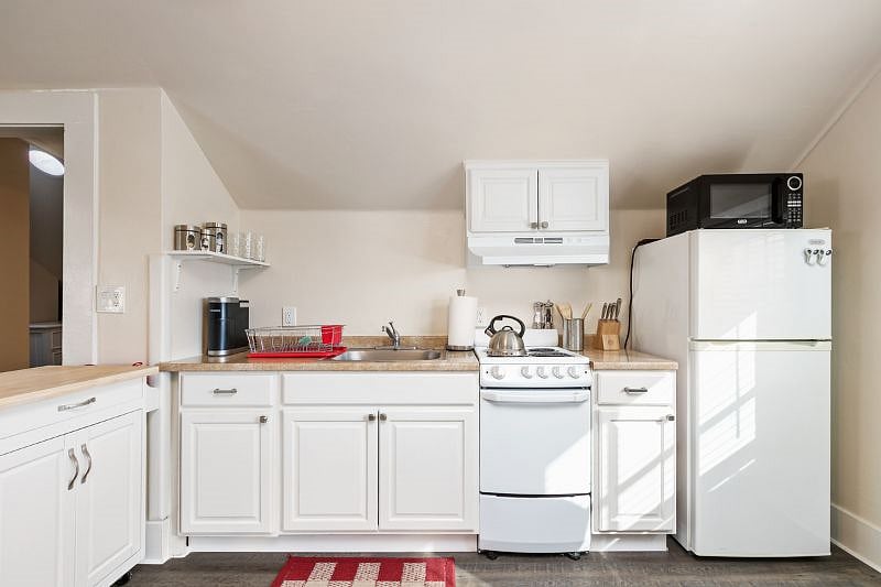 A fully equipped kitchen includes a full size refrigerator, stove with oven, kitchen sink and spices....utensils, pots and pans.