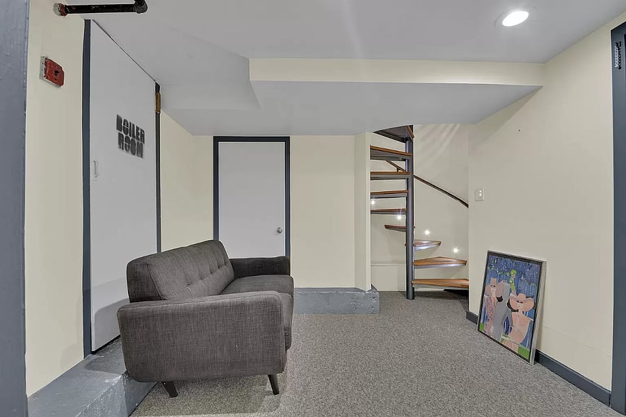 Make yourself at home in this welcoming common area, complete with a plush, cozy couch. The space is perfect for lounging or gathering with friends, providing both comfort and style.