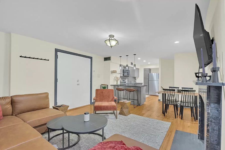Step into a spacious and stylish living room designed with your comfort in mind. A plush couch and ample seating ensure everyone has a spot to relax by the fireplace. The smart TV makes streaming your favorite shows a breeze in this airy, open-concept home.