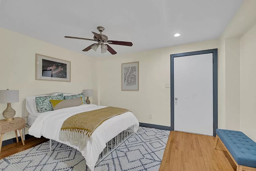 Relax in this serene bedroom featuring a luxurious queen bed. The soft linens and inviting decor create a peaceful space for relaxation and a good nights rest.