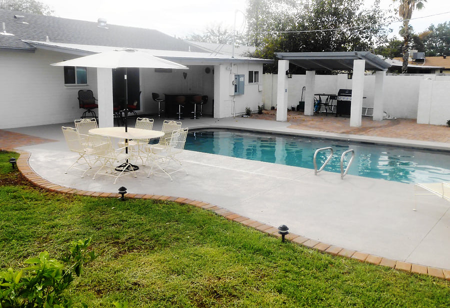 A pergola shades the grill area.