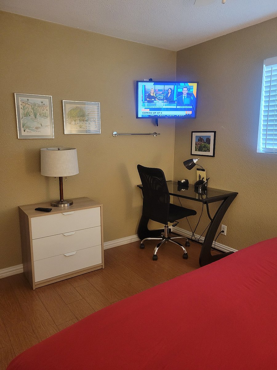 At the foot of the bed in the 3rd bedroom.