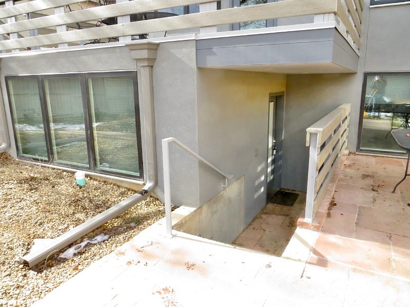 Four stairs down to entry, lockbox on door