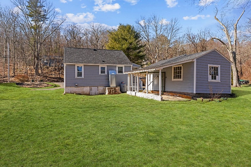 Back of home with private yard (garage used for owner storage) 