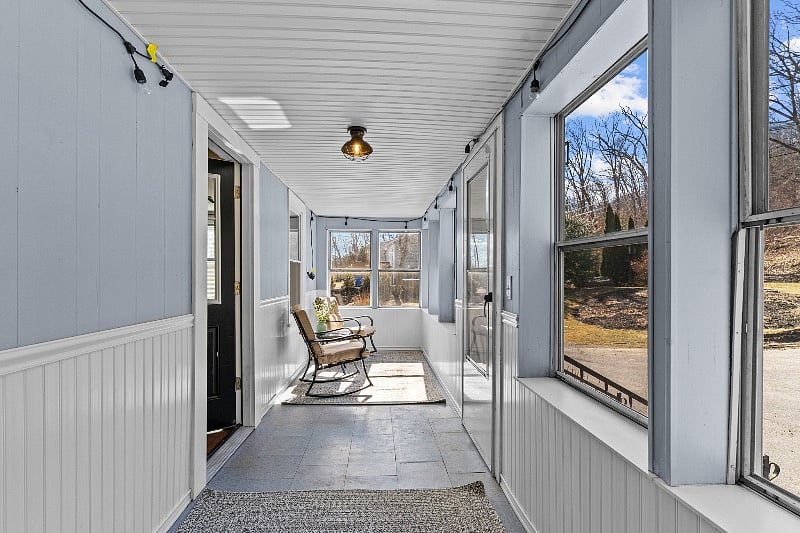 Enclosed from porch sitting area. Stays warm even in winter with bright sun!