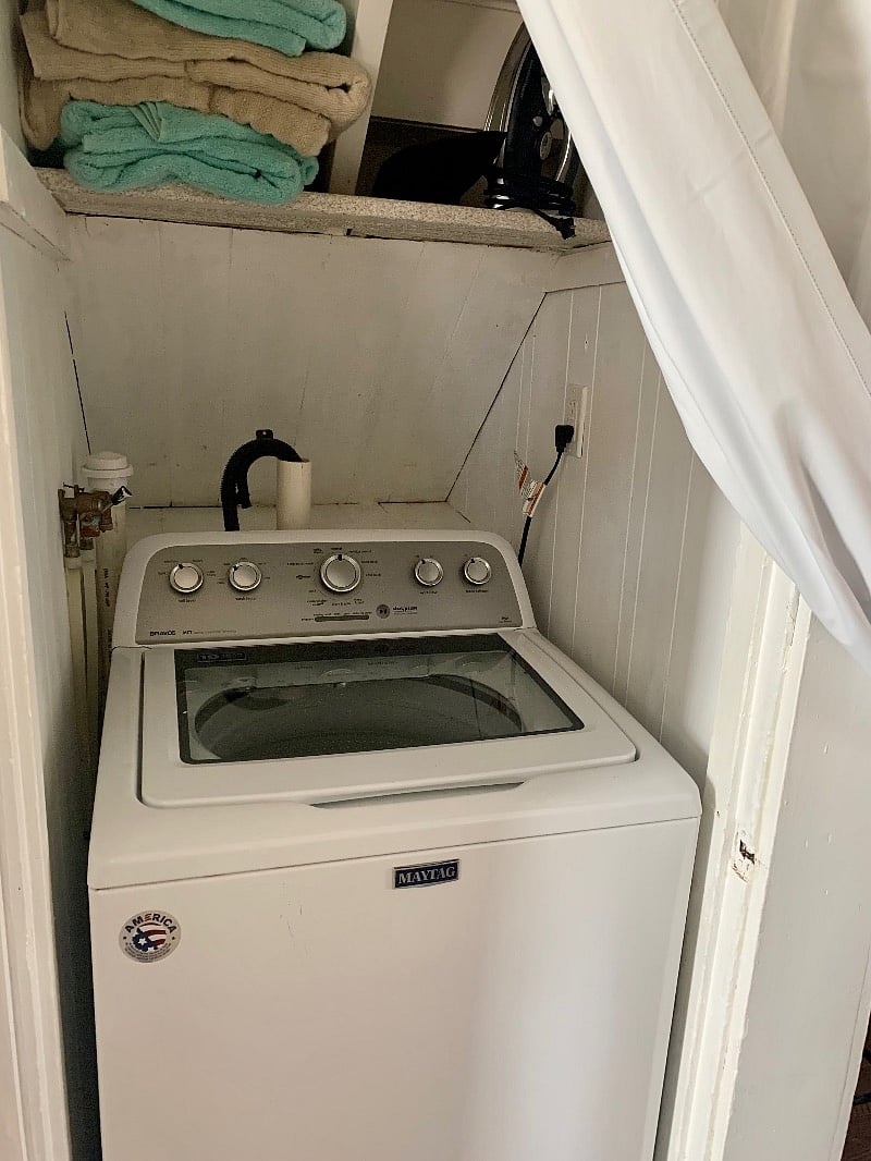 Washing machine across from full bath