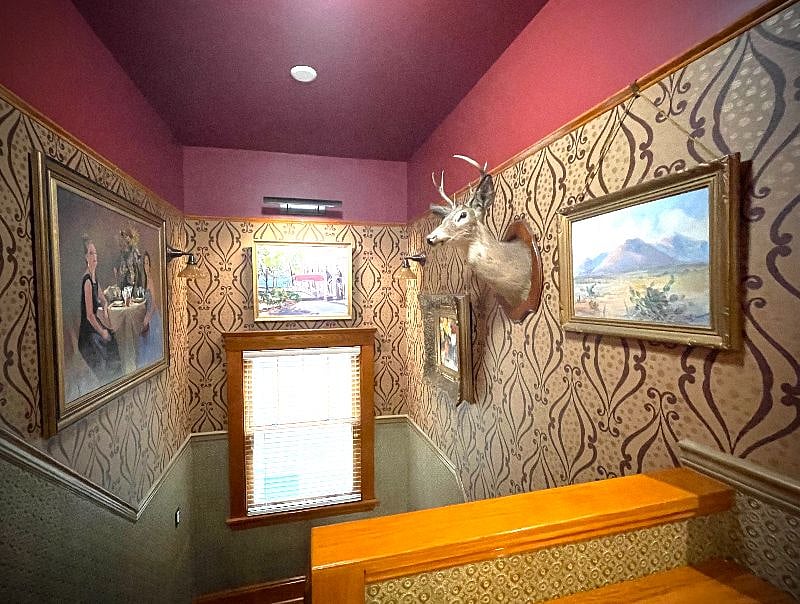 Stairwell entrance to second floor apartment doubles as an art gallery. Original oil paintings, custom painted Lincrusta wainscotting. All lighting on motion sensors for hands-free ease. 