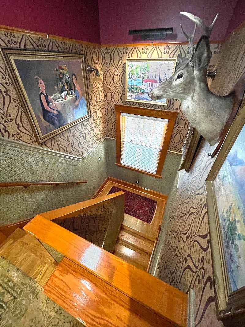 Stairwell entrance to second floor apartment doubles as an art gallery. Original oil paintings, custom painted Lincrusta wainscotting. All lighting on motion sensors for hands-free ease.  