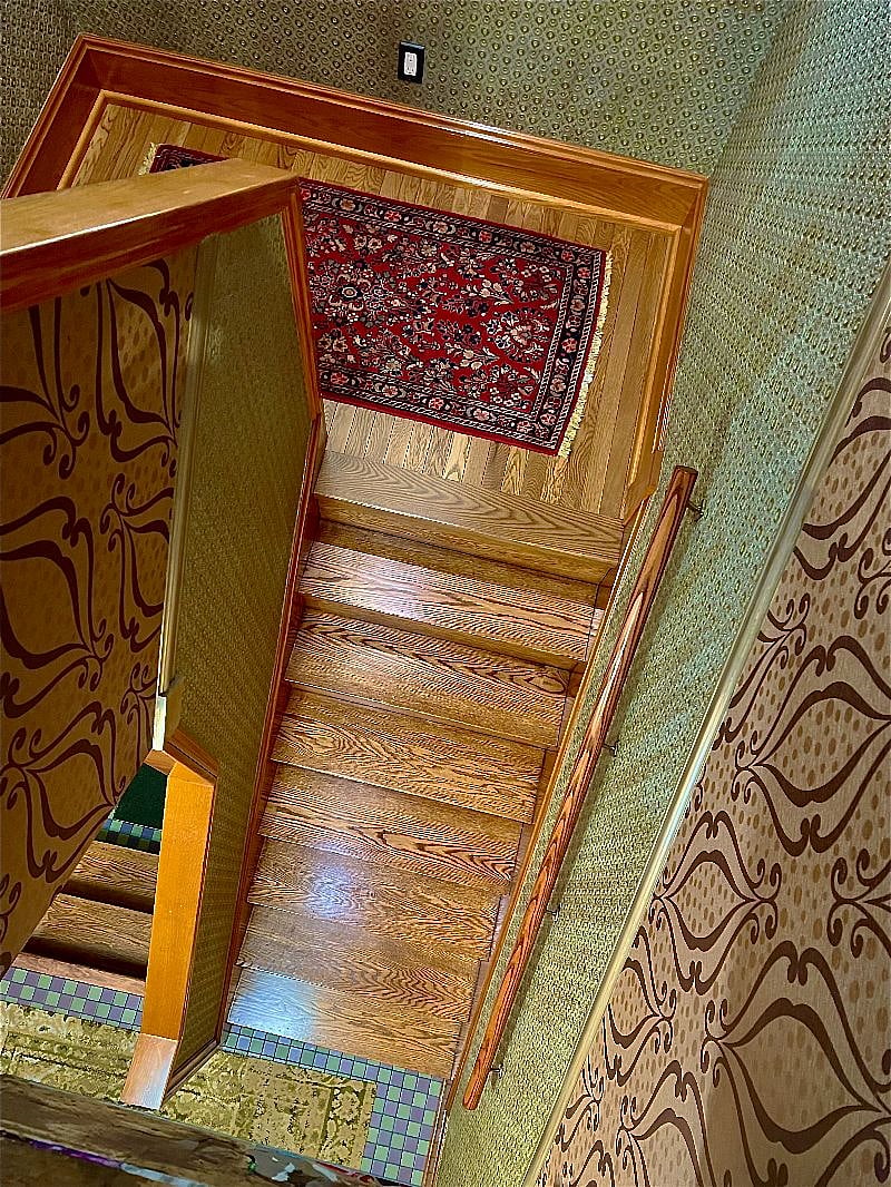 Stairwell entrance to second floor apartment doubles as an art gallery. Original oil paintings, custom painted Lincrusta wainscotting. All lighting on motion sensors for hands-free ease. 
