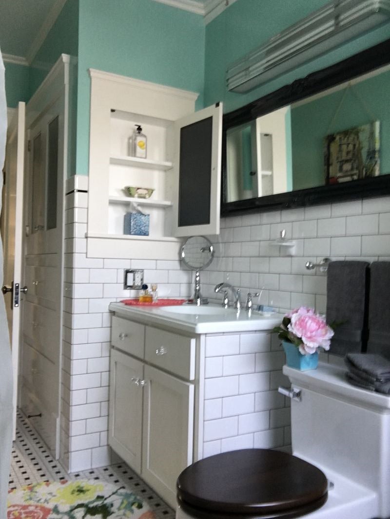 Bright light-filled Bathroom - 100 percent cotton towels, toilet paper, and toiletries provided upon arrival for convenience, subway tile, basketweave tile floor, porcelain tub with shower, Toto toilet, custom vanity with Corian counter and sink, large medicine cabinet, built-in Linen Closet, scale, hair dryer, magnifying mirror.