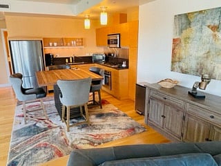Furnished Kitchen with stainless appliances and a bar height table for breakfast/lunch or a quick meal