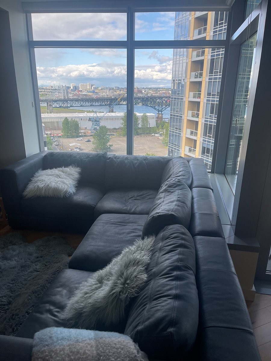 Sectional with large flat screen TV with a great view of the river as you watch tv or relax or enjoy morning Coffee
