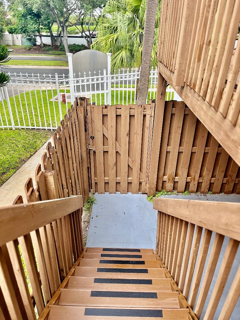 The locked entrance gate and private patio to the right.