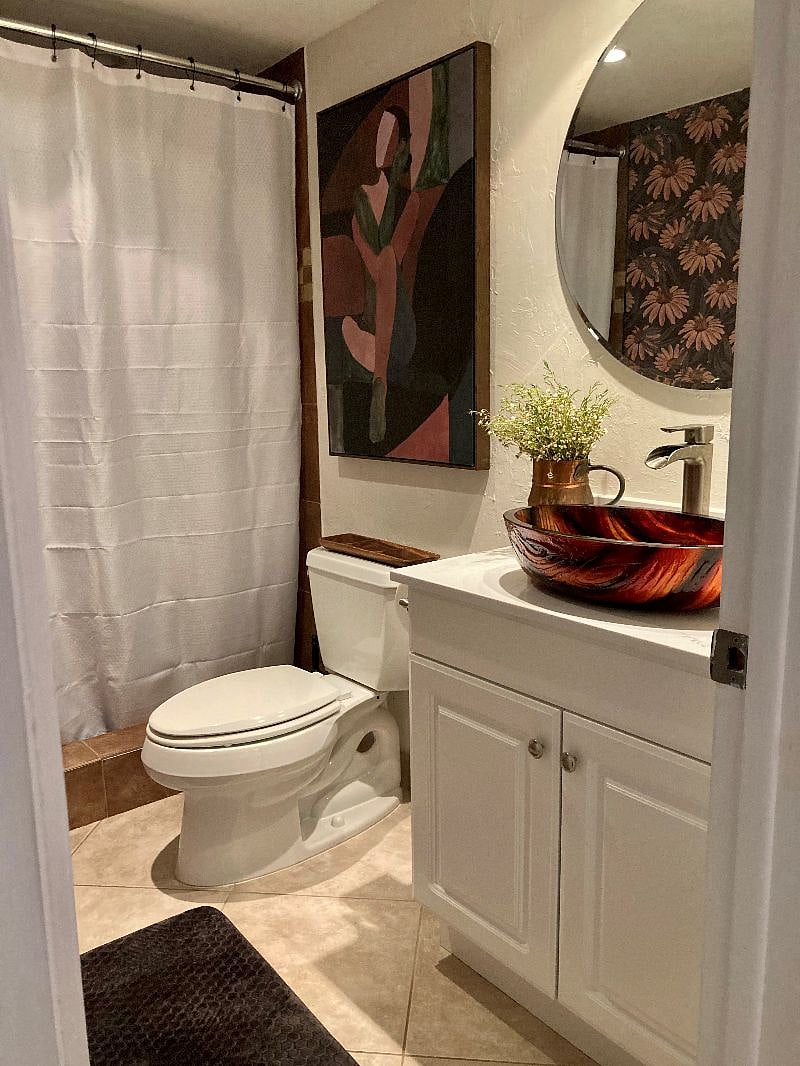 Downstairs bathroom next to bedroom with King bed.